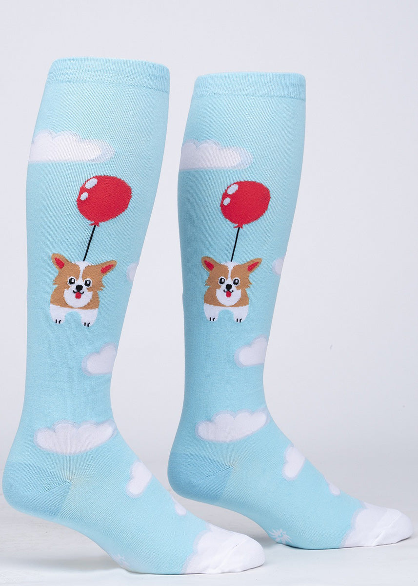 Extra-stretchy knee socks show cartoon corgis floating past the clouds on a red balloon!