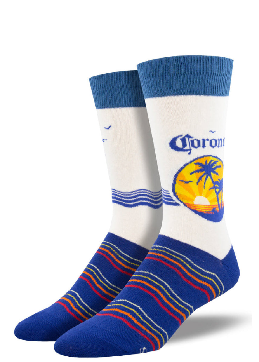 Novelty socks for men featuring the Corona beer logo with a tropical sunset and colorful wavy stripes across the foot.