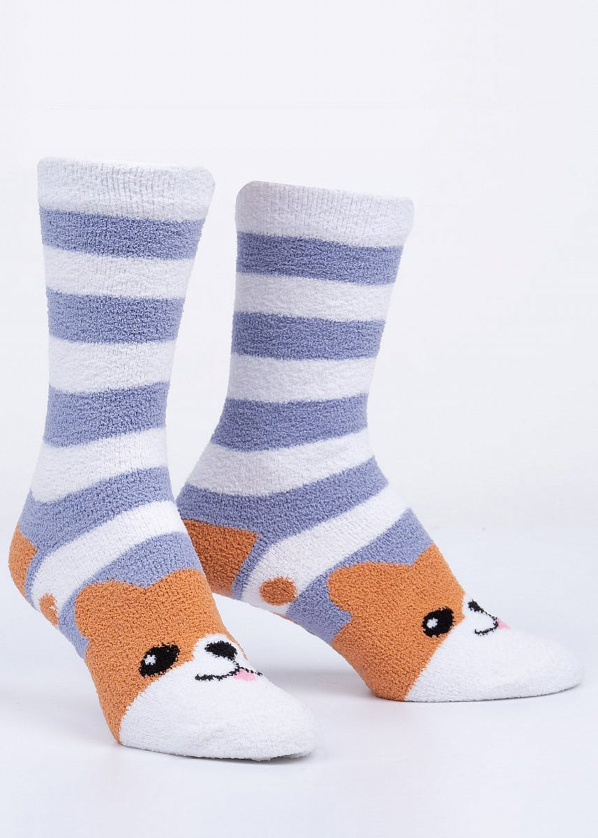 Fuzzy slipper socks feature adorable cartoon corgi faces on the feet with blue and white stripes on the cuff.