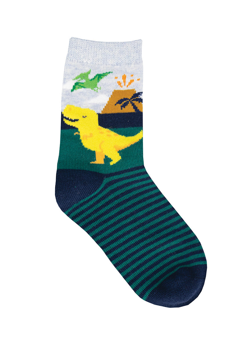 A smiling yellow T. rex walks across these dinosaur crew socks for kids, which also feature a green pterodactyl, a volcano and a palm tree.