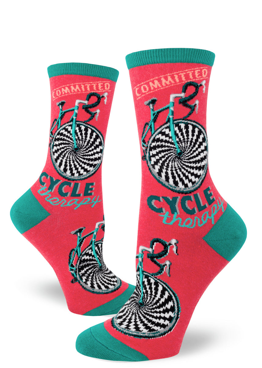 Bicycle socks for women that say "Cycle Therapy" on a red background