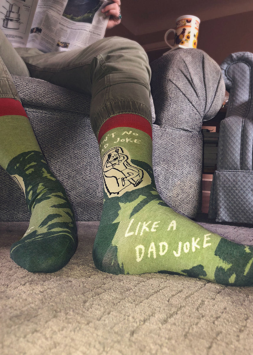 Funny socks for men show a dad chilling in a chair with the words, &quot;Ain&#39;t no bad joke like a dad joke.&quot;
