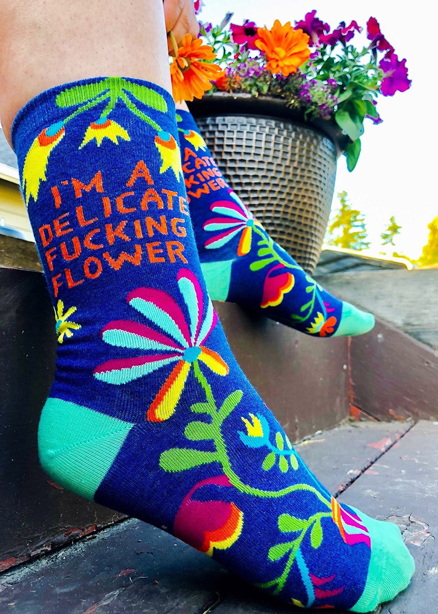 Swear-word socks for women feature abstract floral patterns with the words, &quot;I&#39;m a delicate fucking flower.&quot;