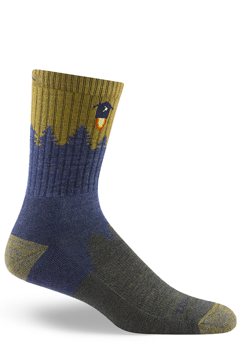 Wool hiking socks for men show a denim forest silhouette with an outhouse rocking into the golden sky!