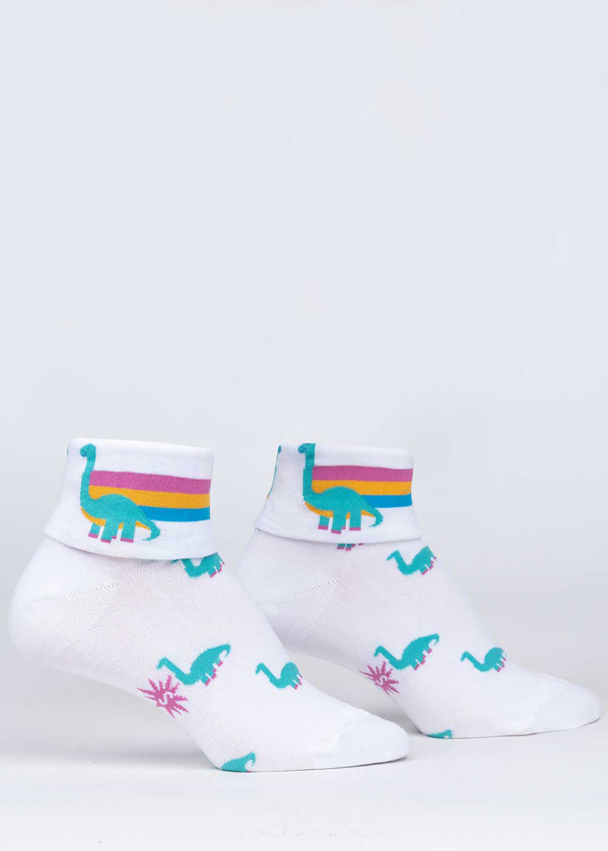 Cute dinosaur socks for women reveal dinosaurs with a rainbow trailing behind them when you flip the cuff down.