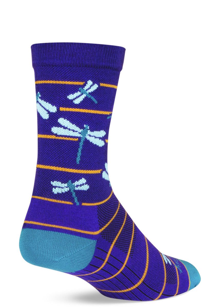 Athletic socks feature light blue dragonflies and thin yellow stripes on a bright indigo background.
