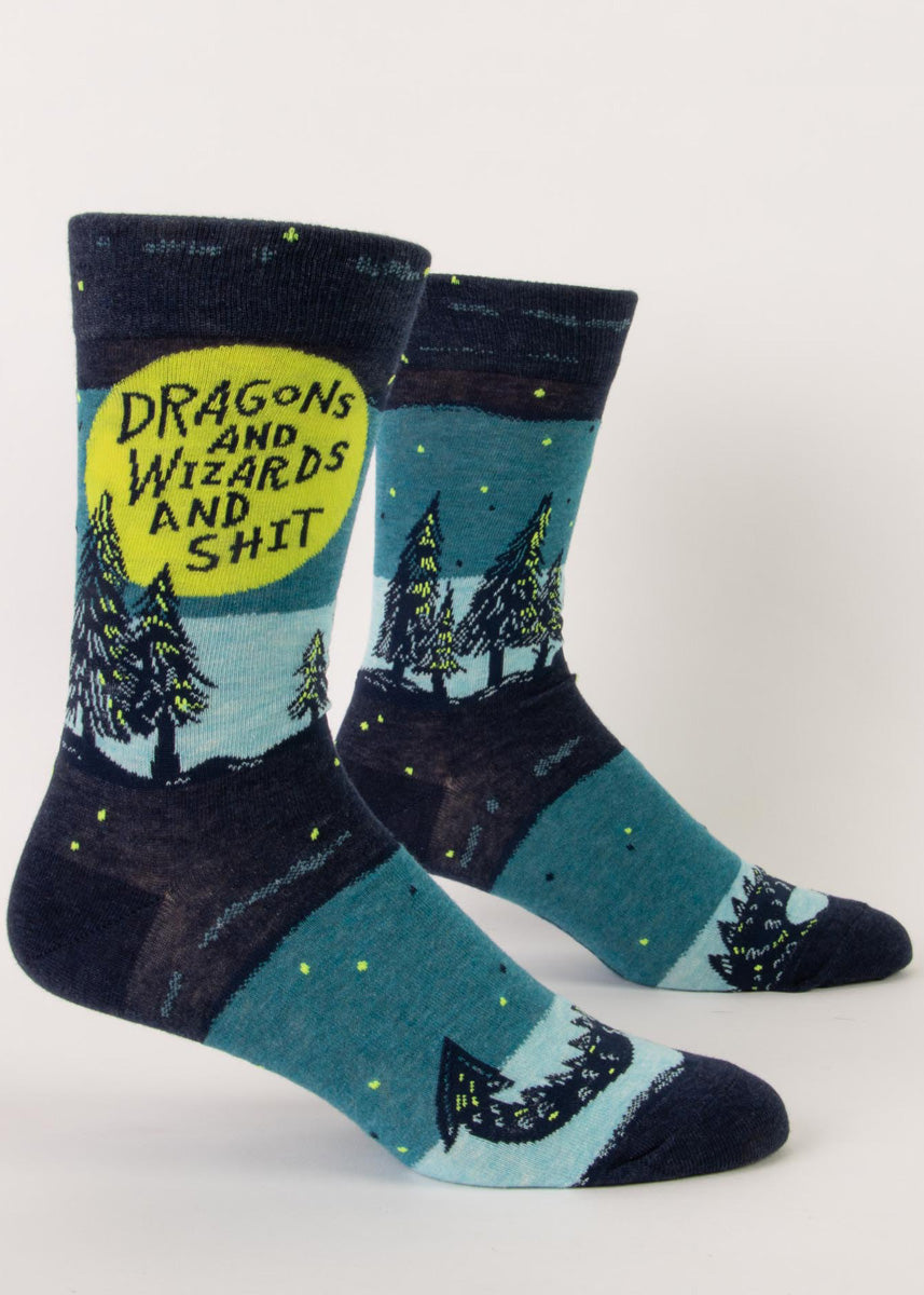 Funny fantasy socks for men show a magical forest and dragon tail with the words, "Dragons and Wizards and Shit."
