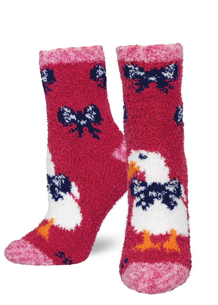 Fuzzy fuchsia crew socks decorated with big white ducks wearing bows, with an accent of pink at the heels, cuffs and toes.
