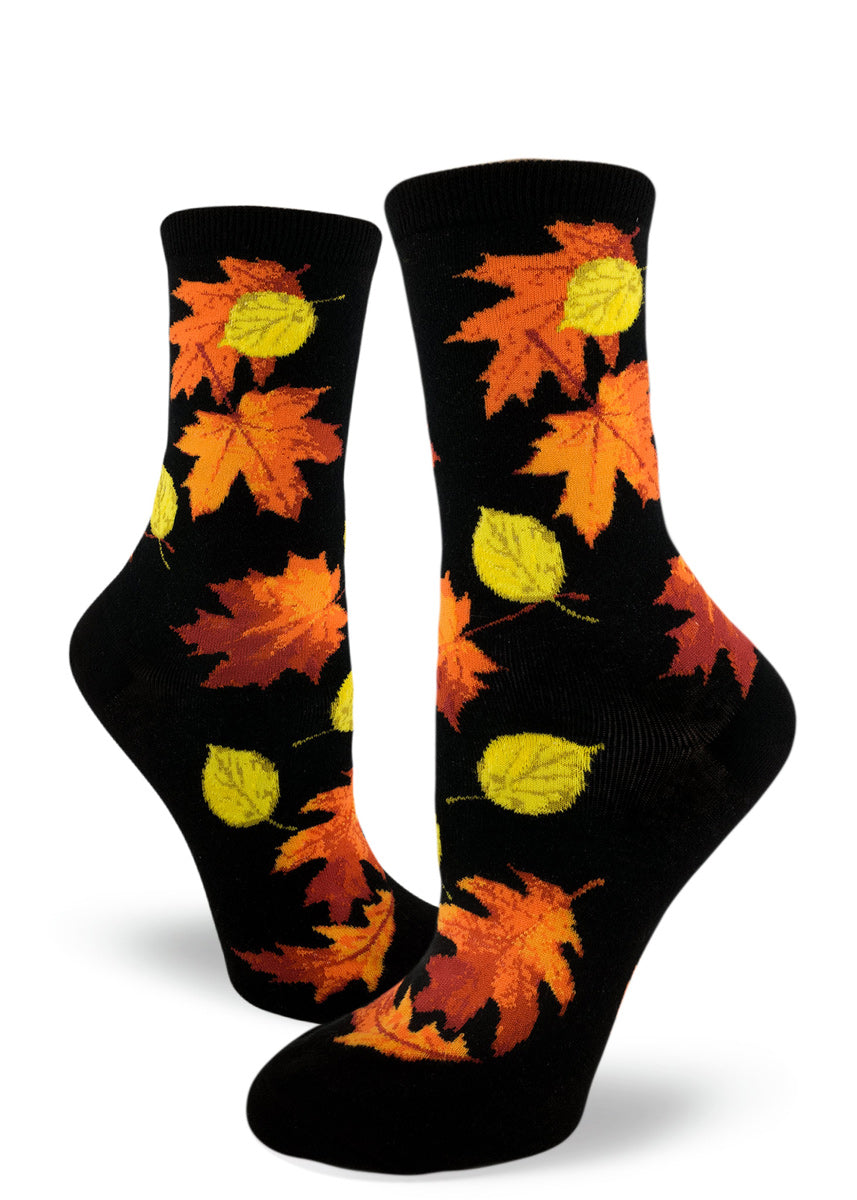 Fall leaves socks for women with orange and yellow autumn leaves on a black background