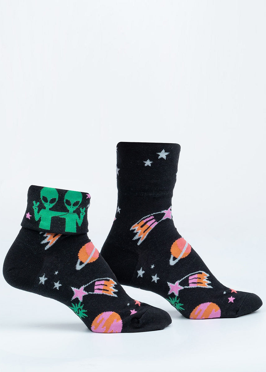 Cute glow-in-the-dark socks feature aliens, planets, and shooting stars with the words "Far Out" revealed when you flip up the cuffs.