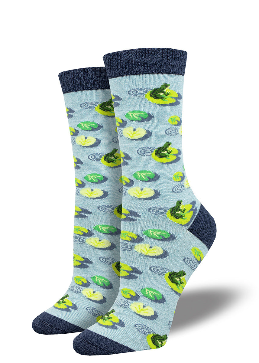 Aqua blue women&#39;s crew socks with a repeating pattern of green frogs perched upon lily pads.
