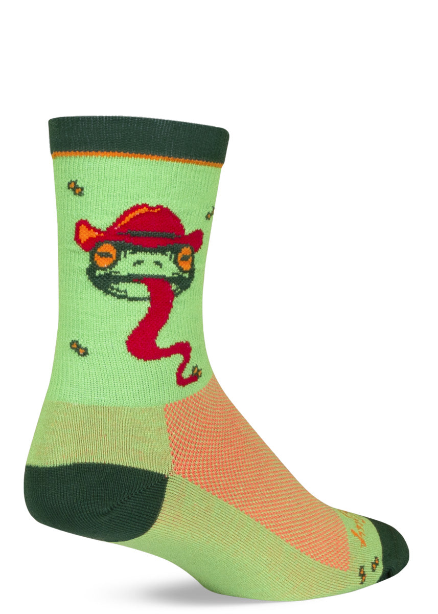 Funny athletic socks feature frog heads wearing cowboy hats and party hats and sticking out their long red tongue on a light green background. 