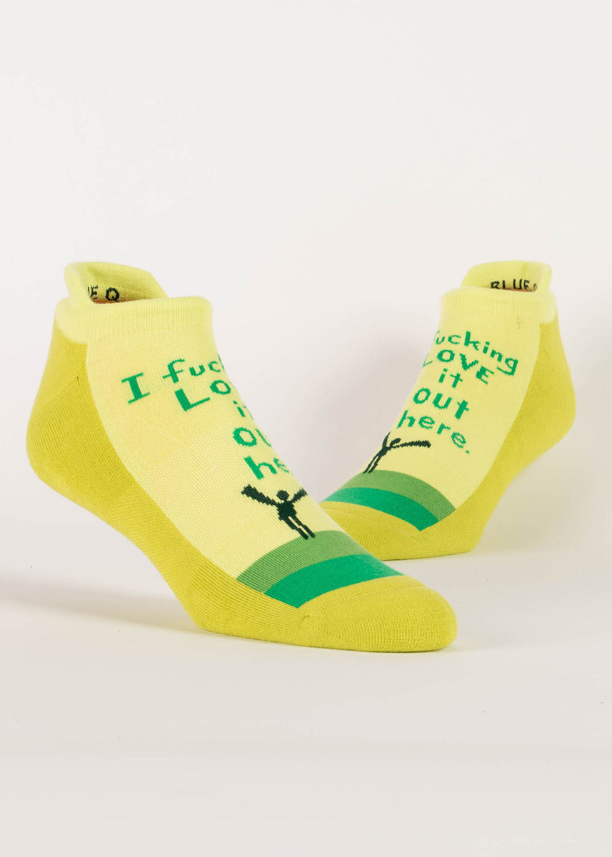 Yellow-green athletic ankle socks with the words, “I fucking love it out here.” 