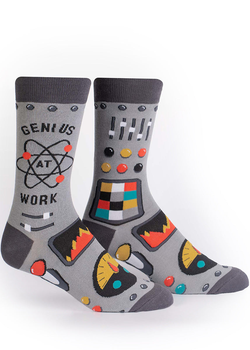 Funny socks for men say &quot;Genius At Work&quot; and feature the atomic symbol, and knobs, buttons and dials in bright colors. 