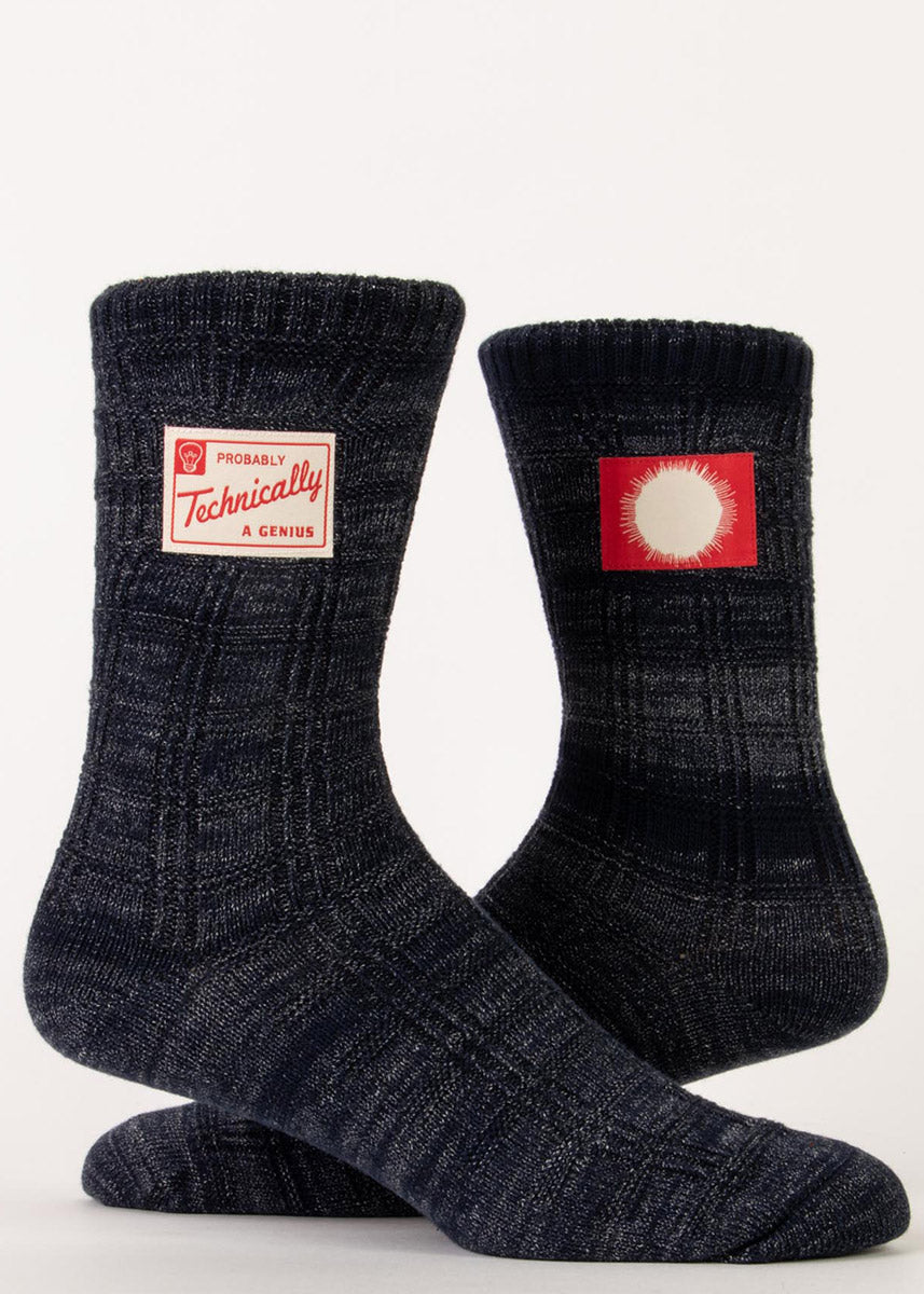 Funny knit socks feature tags that say &quot;Probably technically a genius&quot; on one with a sunburst image on the other on a dark navy space dyed background.