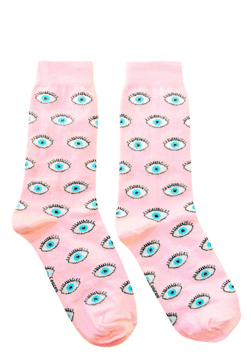 Pink crew socks covered with sparkly blue eyes.