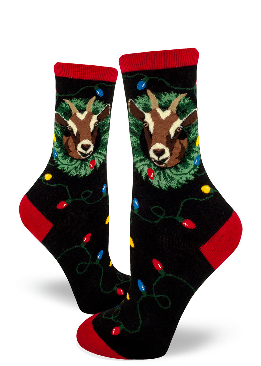 Christmas goat socks for women with goats eating Christmas decorations like wreaths and Christmas lights