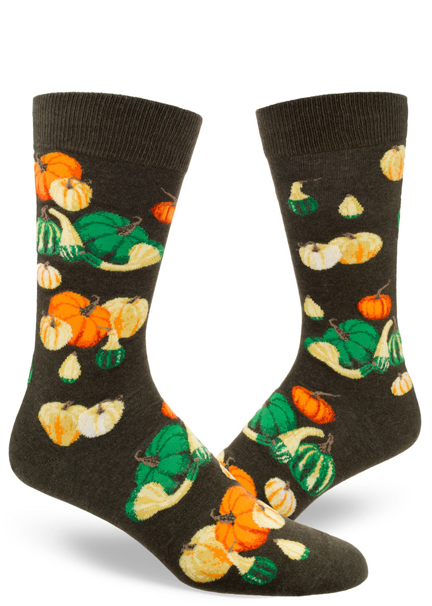 Autumn socks for men feature colorful pumpkins and other gourds on a mossy green background.