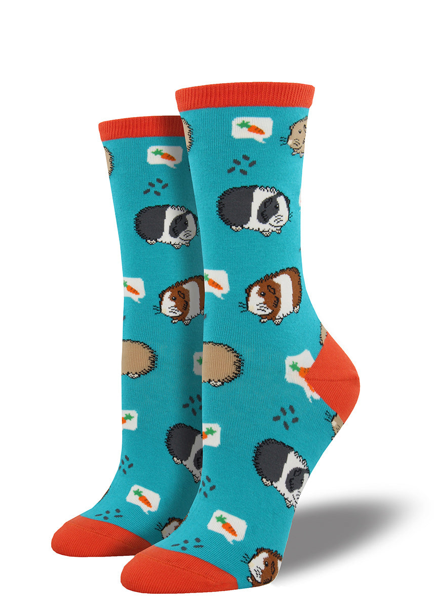 Adorable guinea pigs set against turquoise and bright orange decorate these women's crew socks. 