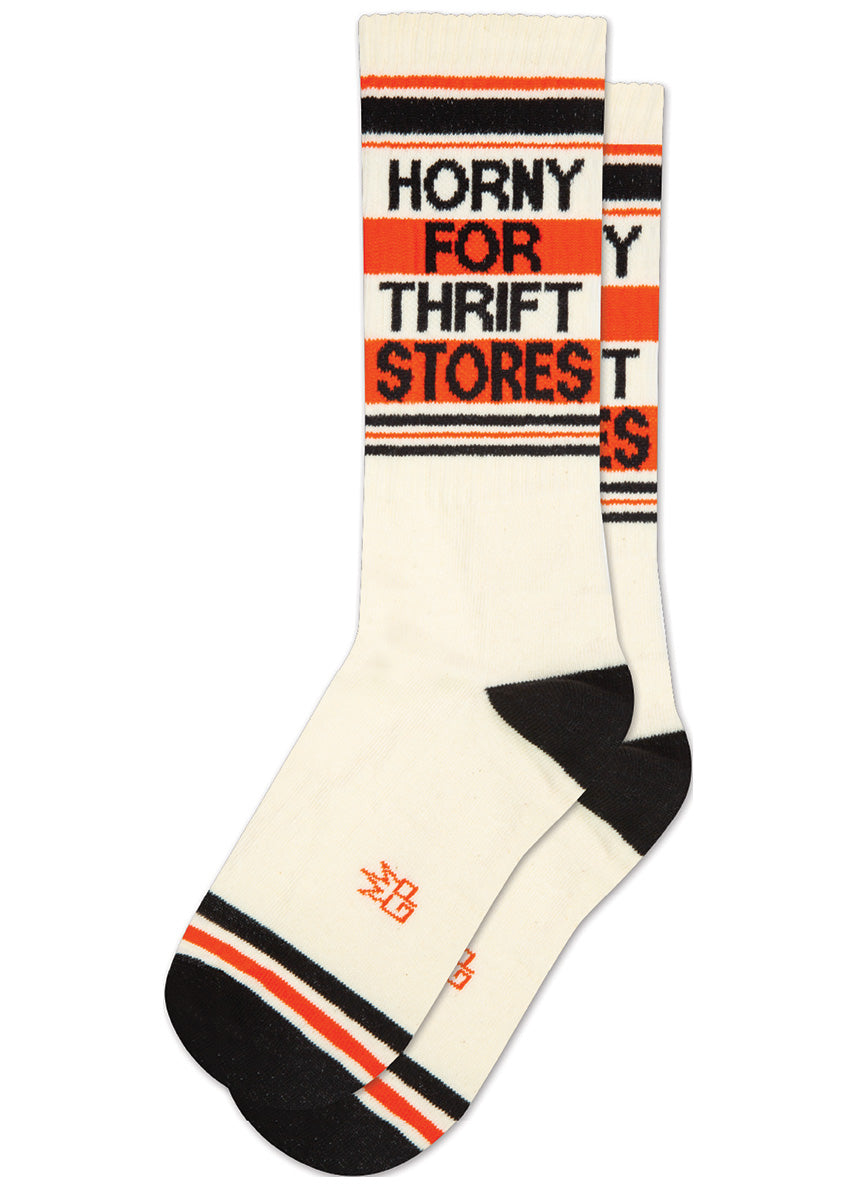 Cream retro gym socks with black and orange stripes and the phrase “HORNY FOR THRIFT STORES" on the leg.