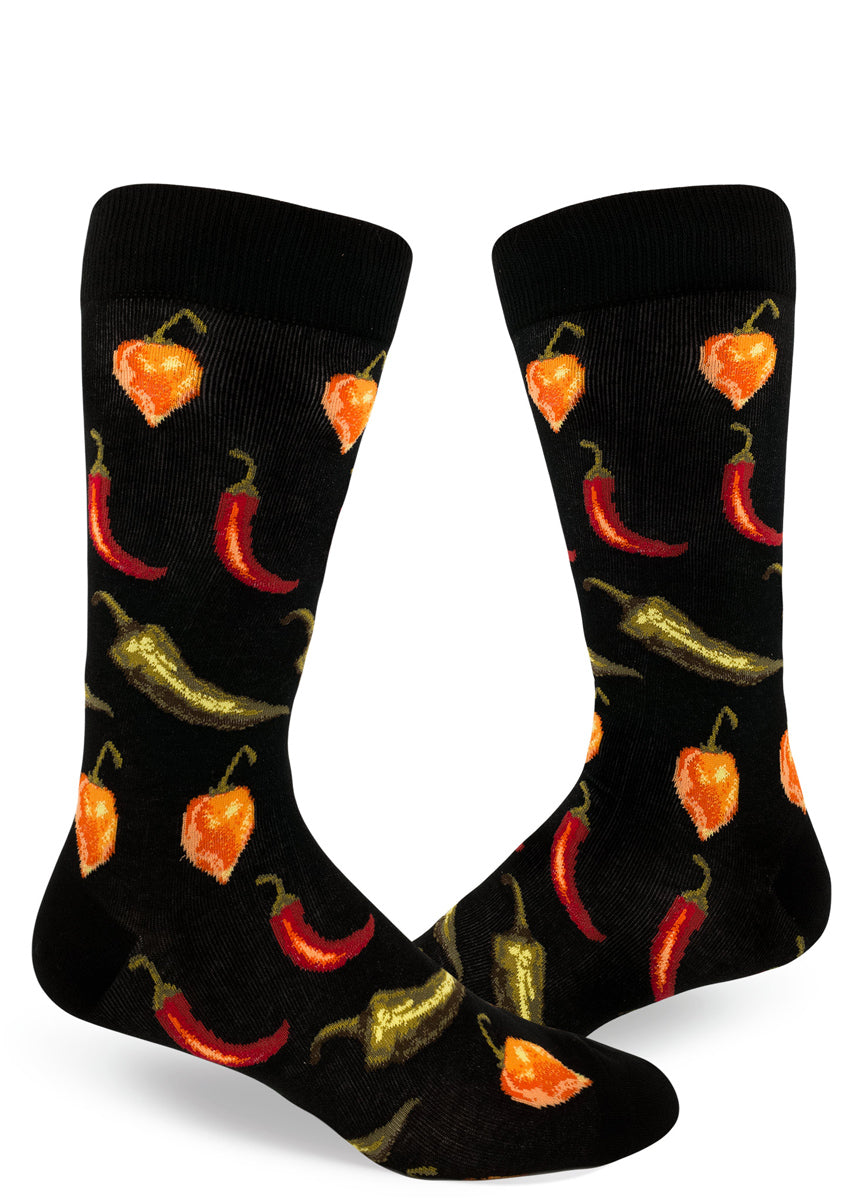 Spicy chili pepper socks for men with orange habaneros, red chiles and jalapeño chilis on a black background