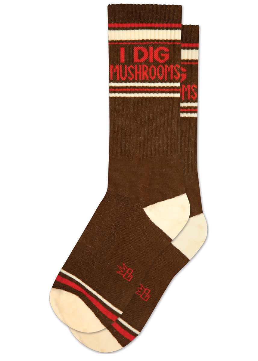 Retro gym socks say "I dig mushrooms" in a red font on a dark brown background with cream accents.