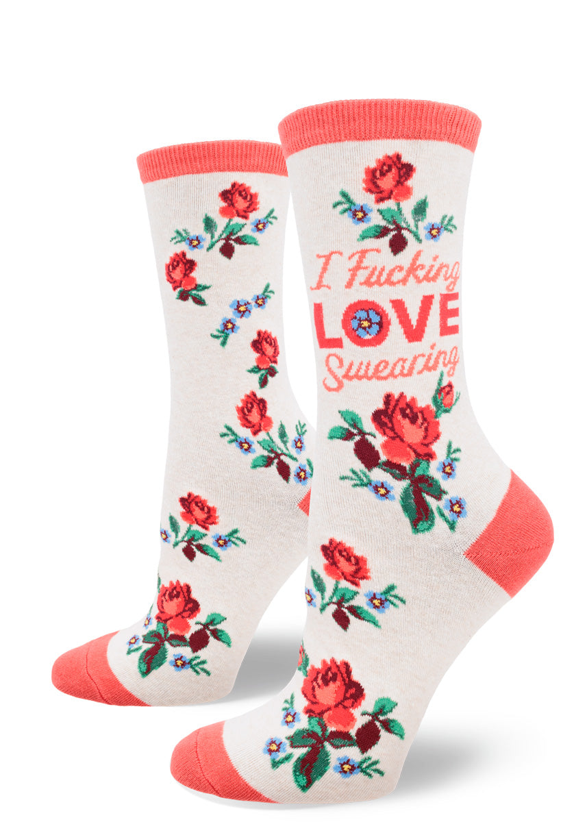 Cream women&#39;s crew socks with coral at the heel, toe and cuff feature bouquets of flowers and the words “I Fucking LOVE Swearing&quot; on the leg.