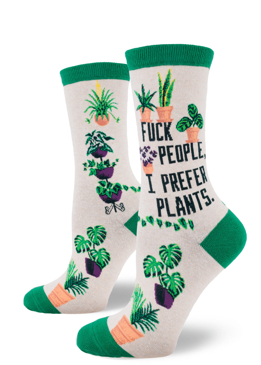 Houseplant novelty crew socks for women in heather cream with green accents have the words “Fuck People, I Prefer Plants” among an assortment of potted plants.