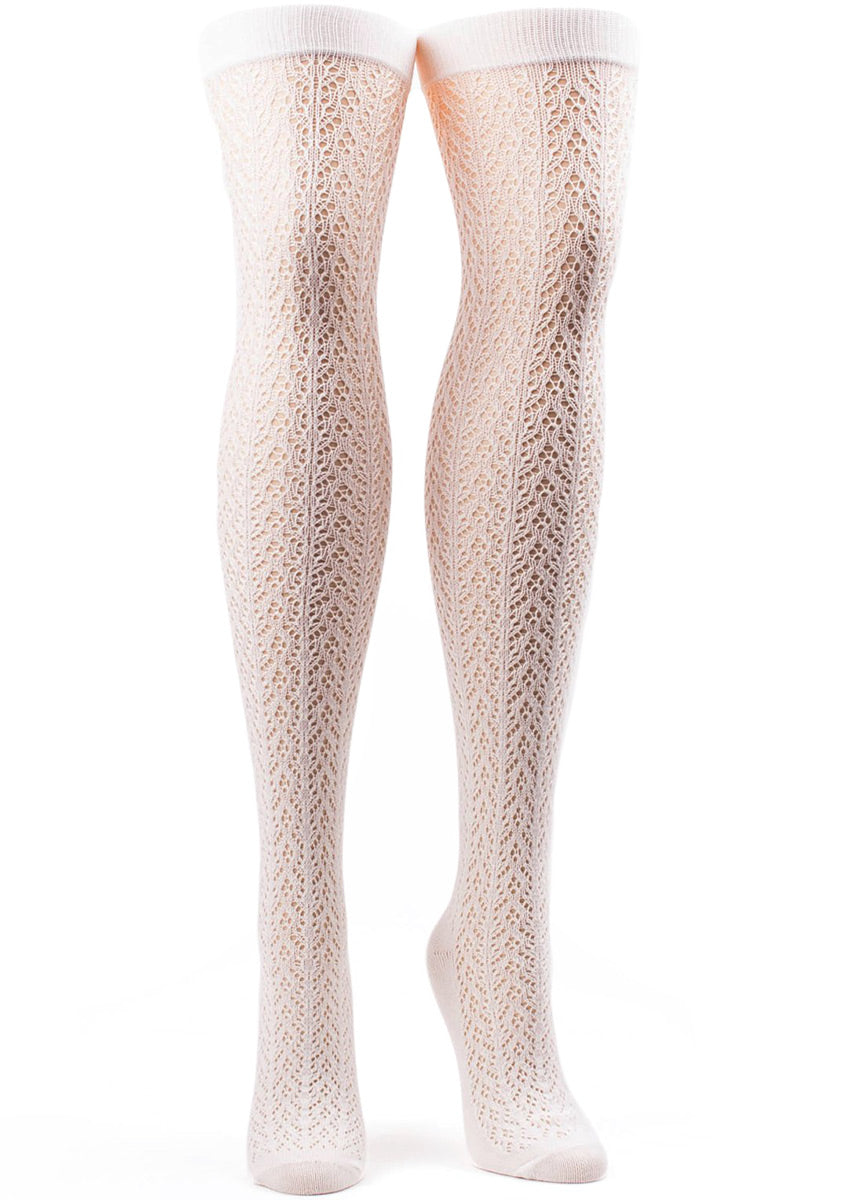 Ivory over-the-knee socks for women with an open crocheted pattern.