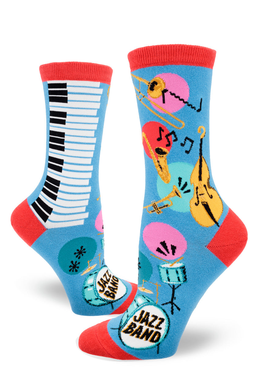 Blue women's crew socks with red accents feature a colorful jazz band design that includes saxophones, trumpets, trombones, standup bass, piano keys and drum sets, plus lots of music notes.