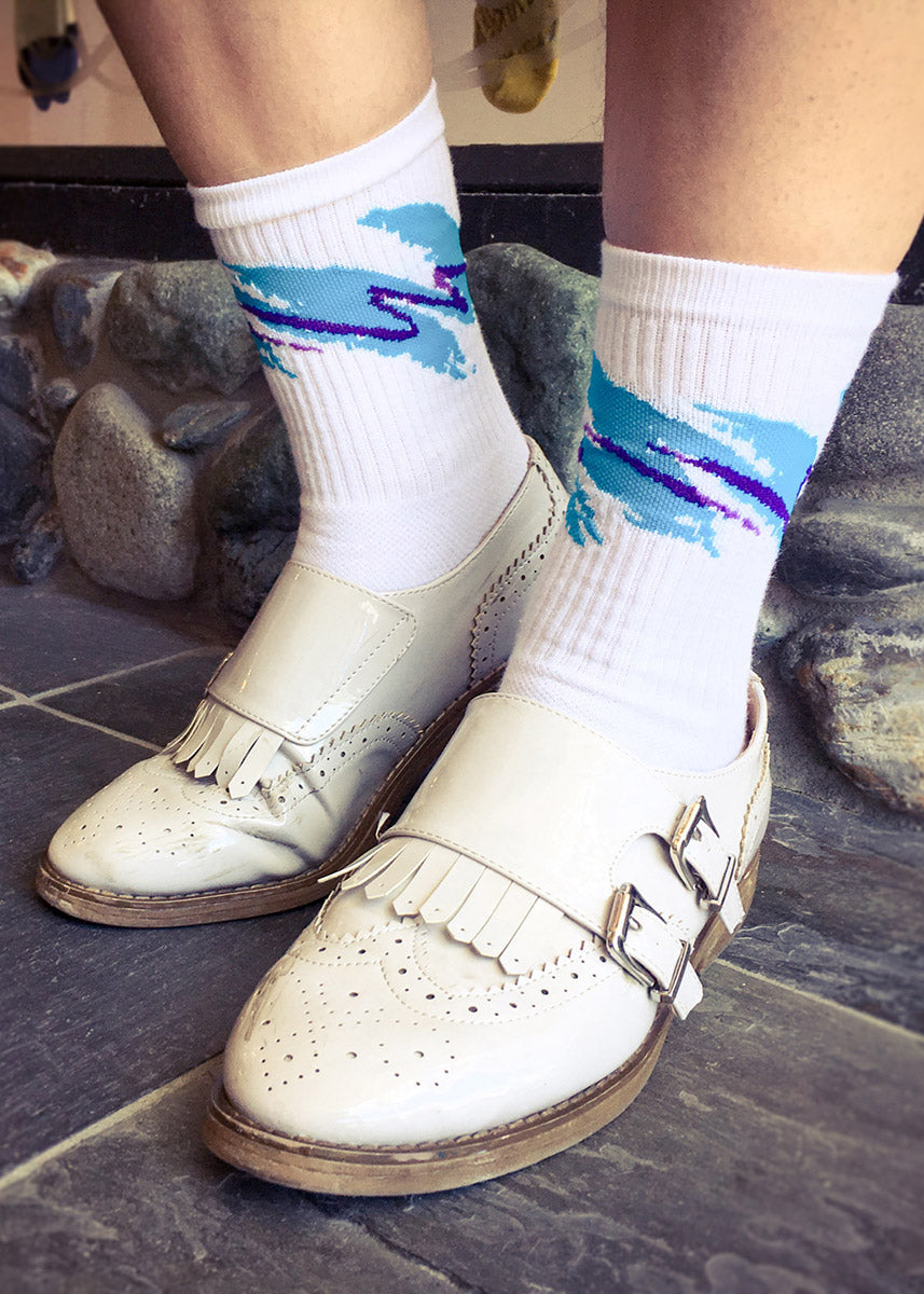 Jazz cup socks with 90s cup pattern with teal and purple swishes on a white background