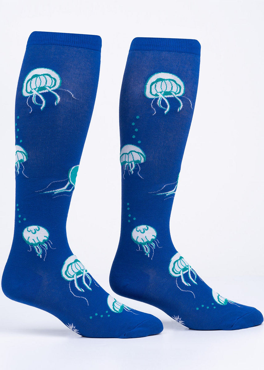Extra-stretchy knee high socks feature glow-in-the-dark jellyfish on a blue background.