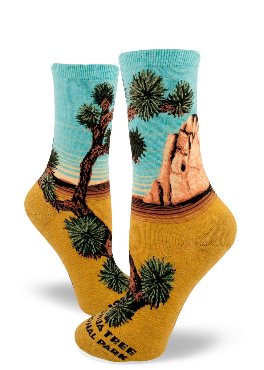 Joshua Tree crew socks for women feature a gorgeous desert scene with golden sand, a rock formation, and yucca trees!