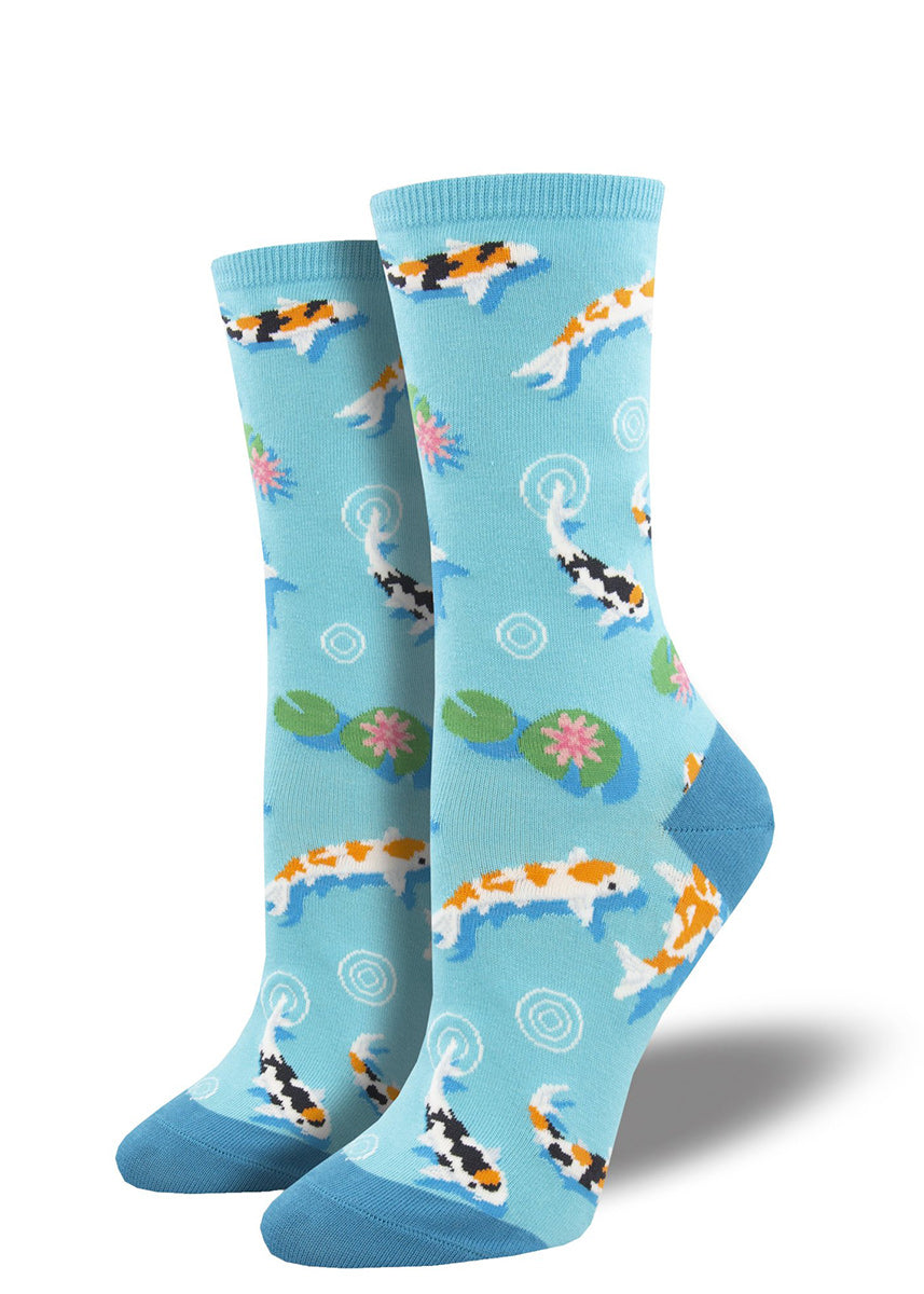 Crew socks for women feature koi fish and lily pads in a light blue pond.
