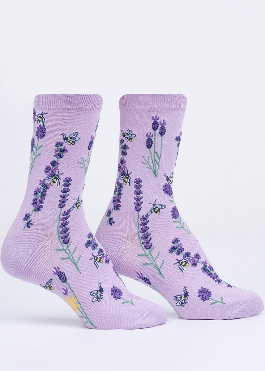 Cute floral socks showing honey bees buzzing around blooming stalks of lavender, in shades of purple.