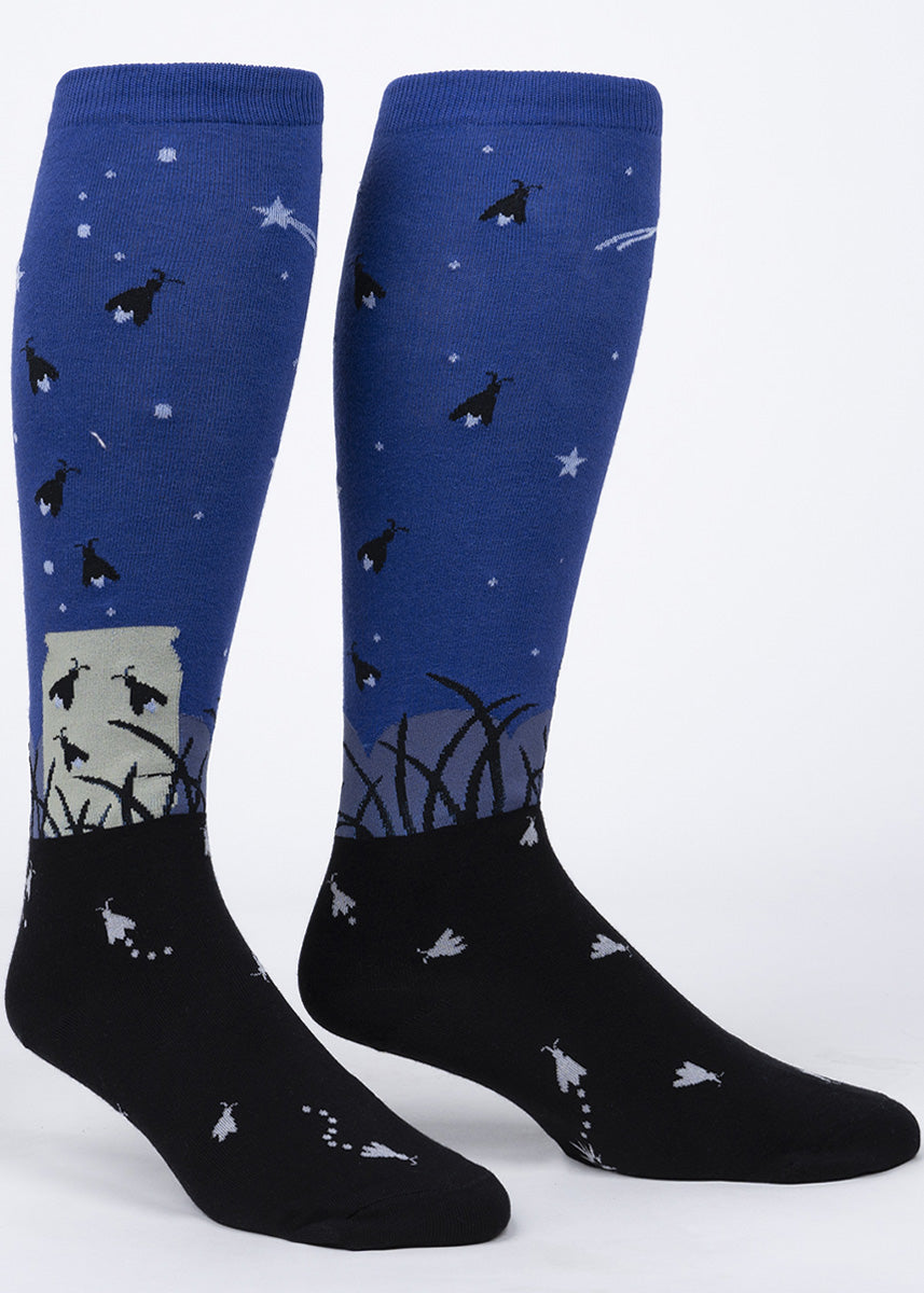 These extra-stretchy knee high socks feature lightning bugs flying out of a jar and into the night sky and incorporate glow-in-the-dark elements!
