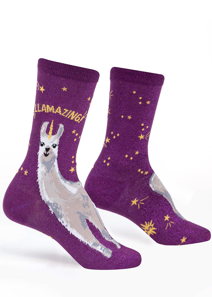 Purple glitter socks for women show llamas with unicorn horns surrounded by stars and the word, "Llamazing!"
