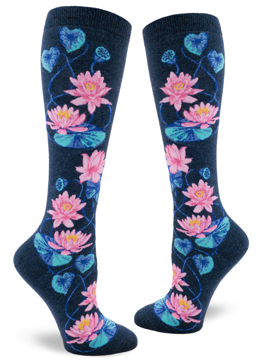 Lotus knee socks feature pink flowers with blue foliage and seed pods against a heather navy background.