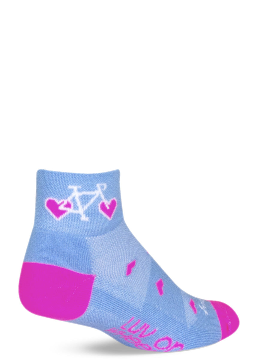 Blue ankle socks with bikes at the cuff with heart-shaped wheels, and pink hearts and the message “LUV ON WHEELS” on the foot.