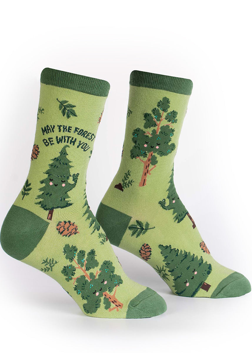 Green crew socks for women with adorable smiling trees and the words, "May the forest be with you."