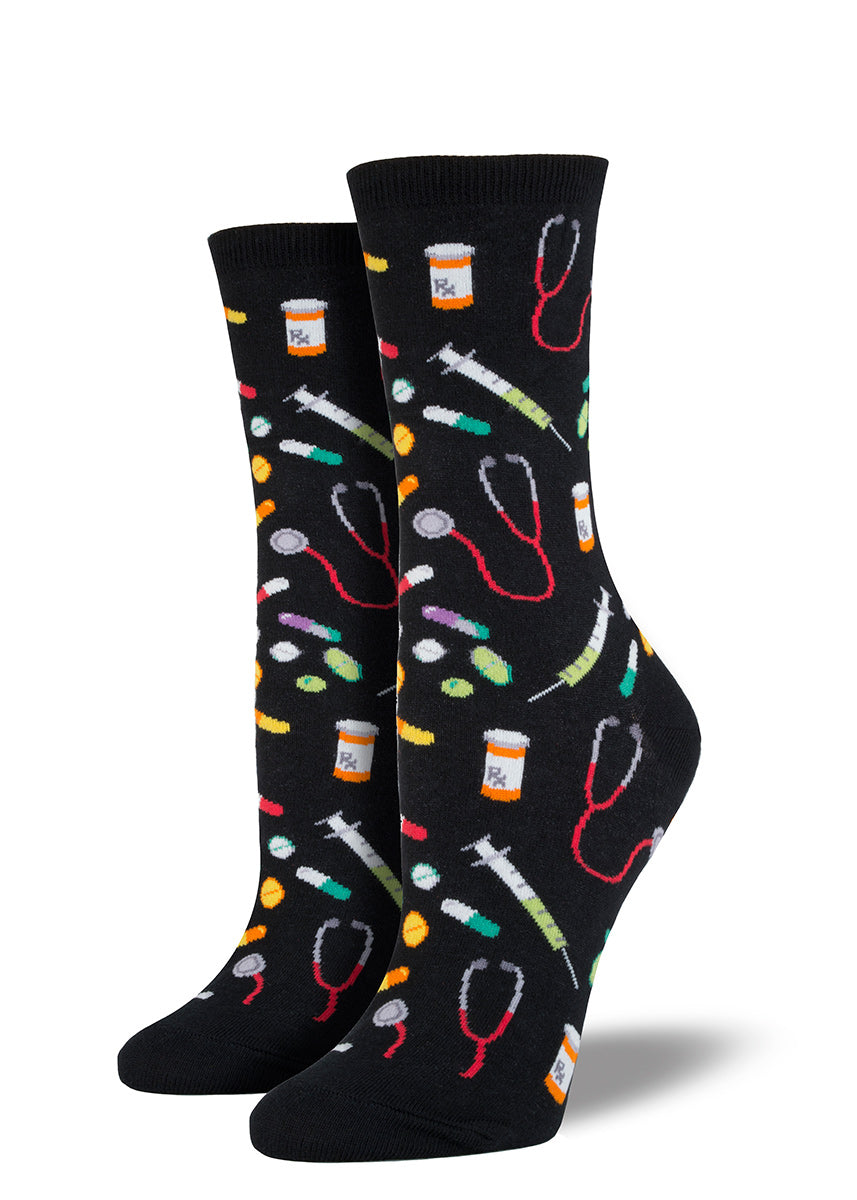 Medical socks for women with pills, stethoscopes and syringes on black socks