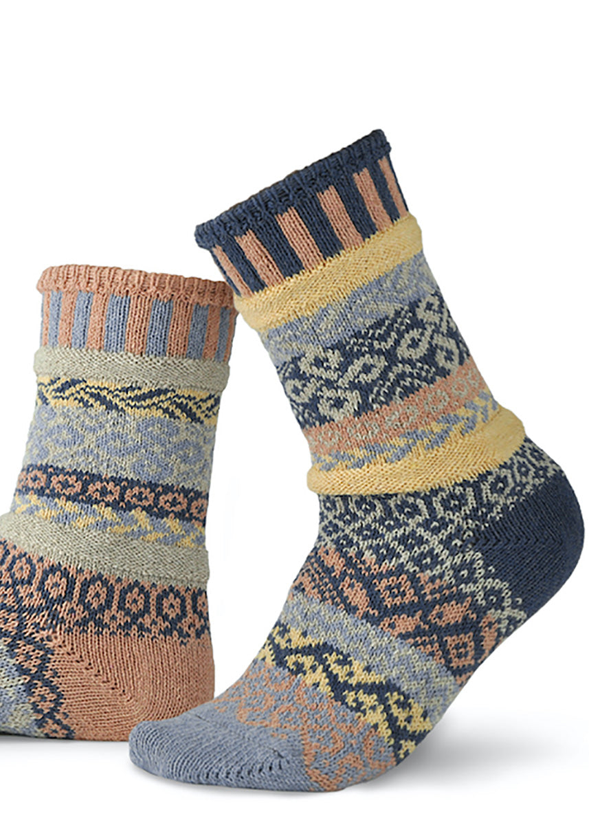 Cozy mismatched pattern socks in peach, pale yellow, dark blue, and light blue.