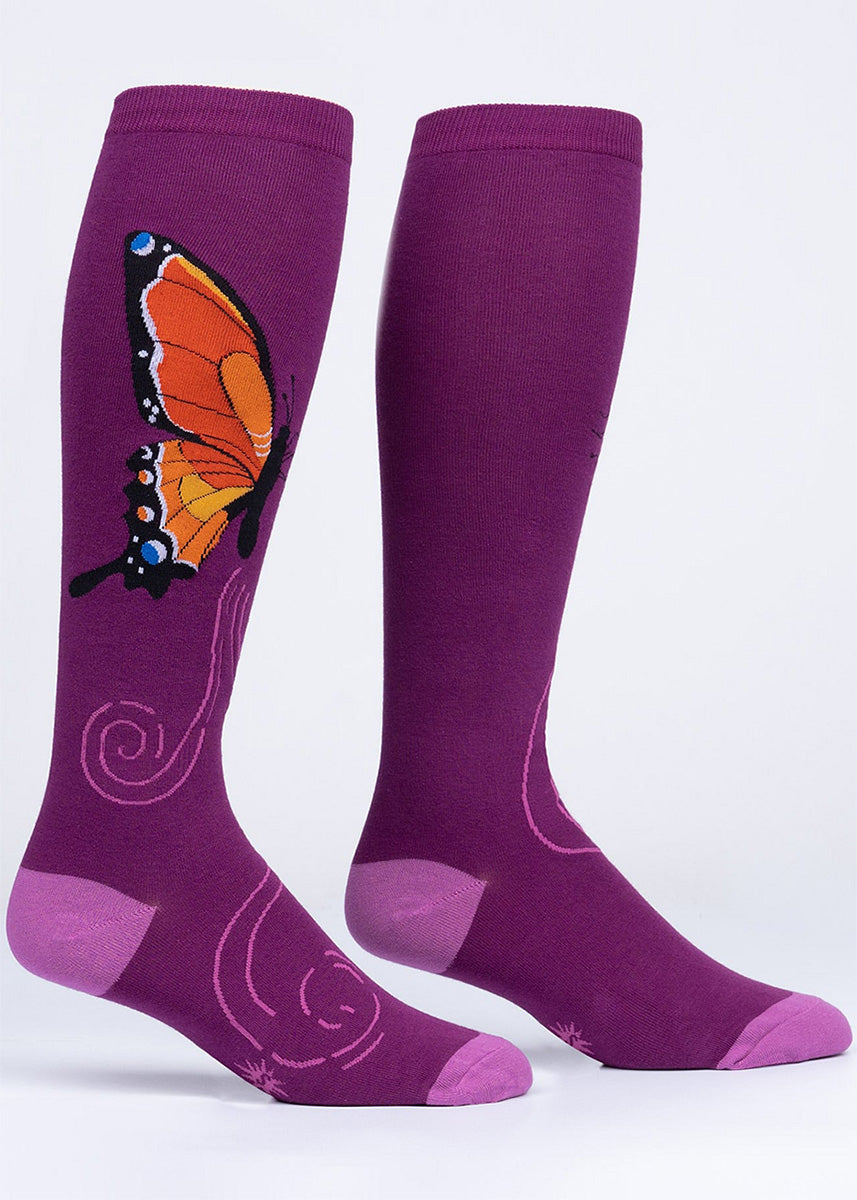 Purple butterfly knee socks with a vibrant orange monarch butterfly wing on the outside of each leg.