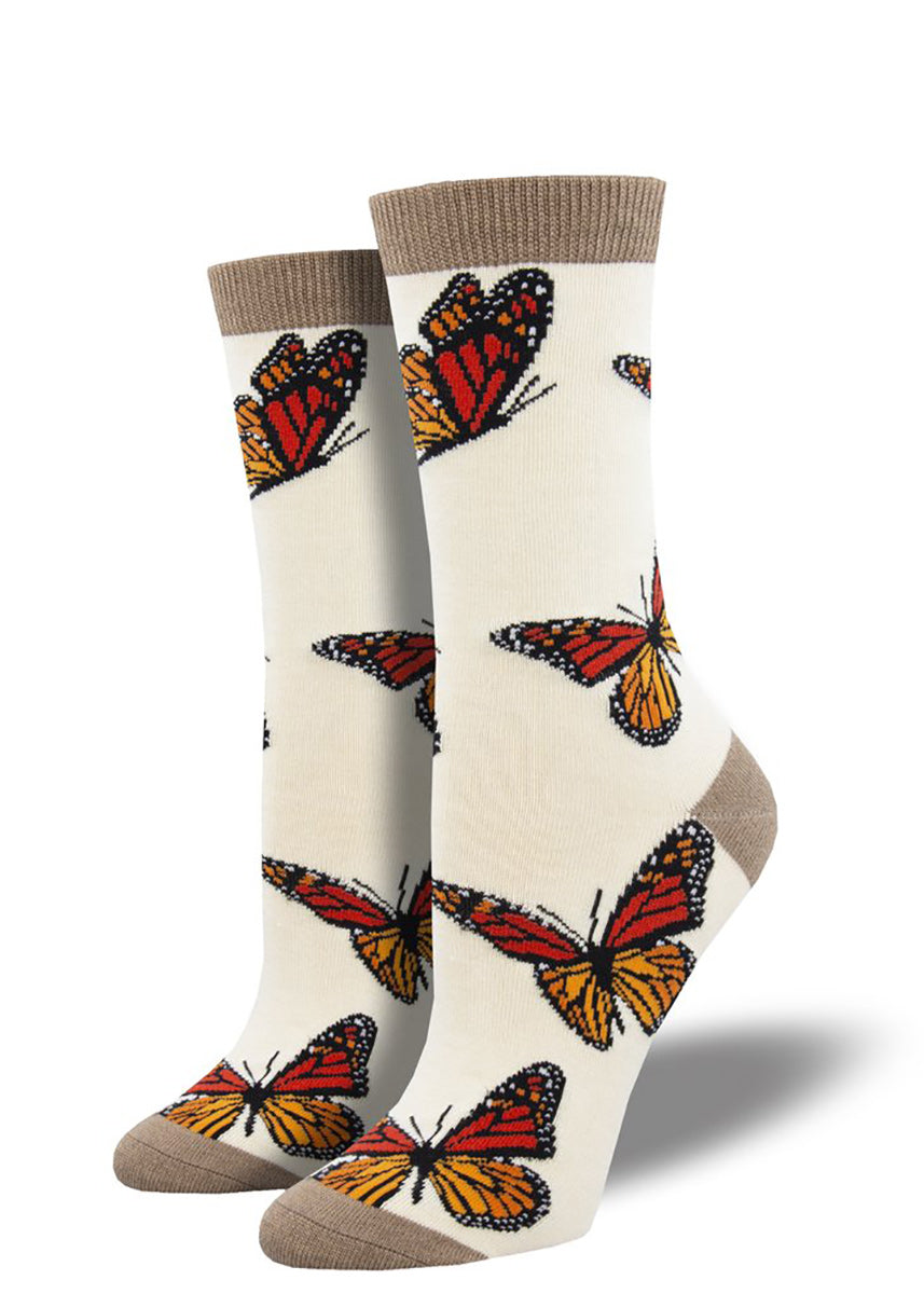 Monarch butterfly bamboo socks on cream background with brown heels, toes and cuffs