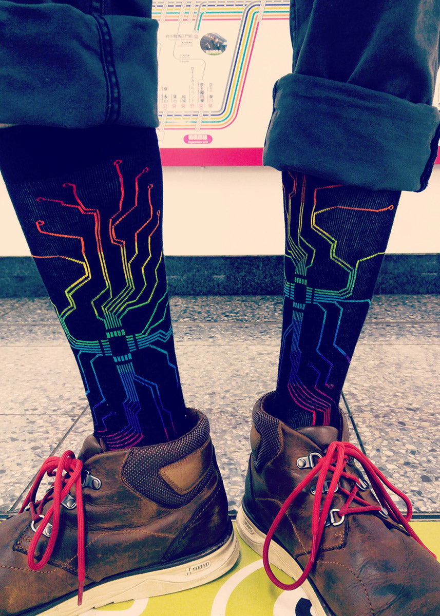 Rainbow motherboard socks for men with nerdy rainbow circuitboards on a black background