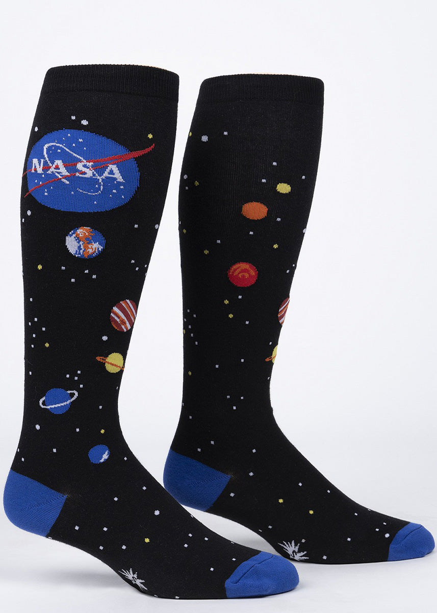 Extra-stretchy knee high socks for women feature the NASA logo in front of a night sky full of stars and planets!
