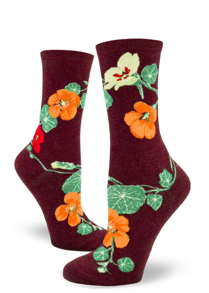 Crew socks for women with yellow, orange, and red nasturtium flowers on a dark red background.