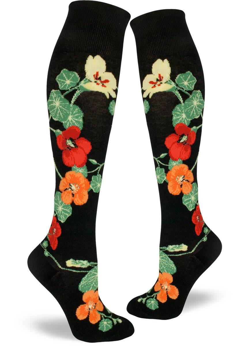 Knee-high socks with nasturtiums in bright orange, red and yellow on a black background
