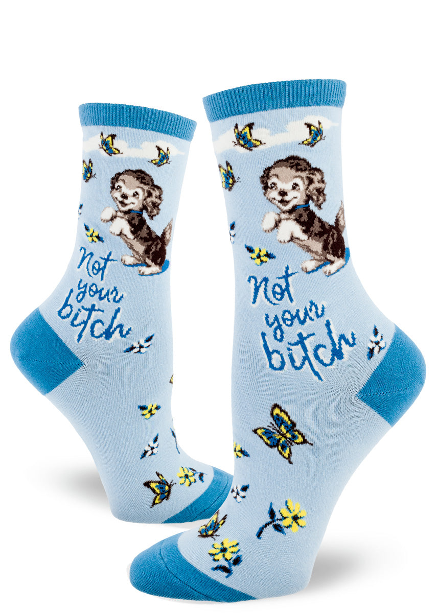 Cute swear word socks for women show an adorable puppy watching butterflies with the words, "Not your bitch."