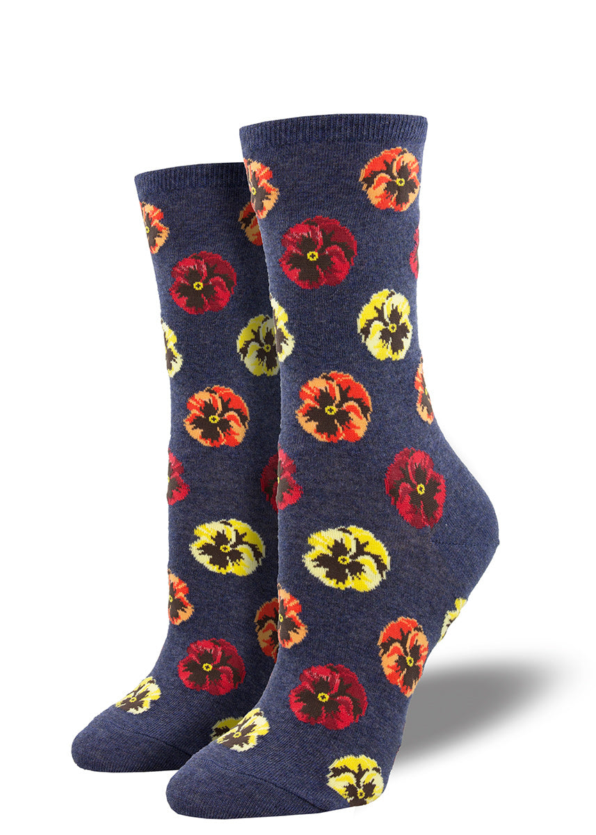 Crew socks for women feature pansies in red, orange, and yellow on a heather blue background.